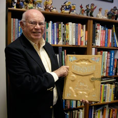 Dave Smith shows off the lavish prop book from the opening sequence of 