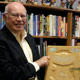 Dave Smith shows off the lavish prop book from the opening sequence of 